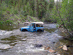 Getting out to tie a strap. Dave was wet to the hips and water was running through to the bottom of the seats.