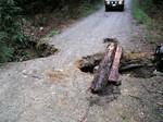 Mark felt the road give way as he drove over, Dave got over and it fell away further underneath him, so we had to stop and bridge it a bit for Andy and Shawn. About 4 feet deep, the water had washed around a deeply buried culvert pipe. This was on a fa...