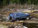 Chris & his Pathfinder cross the creekbed.