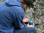 Jeremy McEachern (Jim's eldest son) drills holes for his dad's memorial plaque on a rock overlooking the Placer Mtn. lookout.