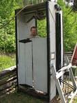 Your fearless leader in what could be an automatic 'outhouse' - nope - it's a car for decending into the mines now at the Bralorne Museum.