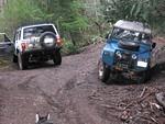 After winching out, turning around, dumping the truck on it's side completely in the washout again, Dave prepares to head back down the hill. He hasn't got the wheels straightened up yet after the tipover experience.