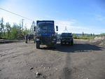 The unicat Unimog next to Petes truck at the Ross river ferry