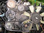 Lots of belts and pulleys, most of which will disappear. Note the angle which the engine sat at in the Peugeot.